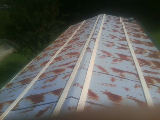Rusted metal roof panels with new wood purlins before replacement — Storm Damage Roof Repair in Trail by Roofing Brothers